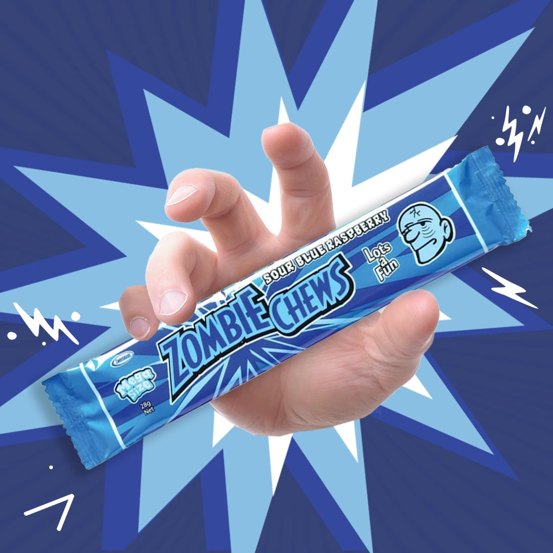 Hand holding a Sweetsman Zombie Chews Sour Blue Raspberry candy bar against a dynamic blue background with a comic-style burst.