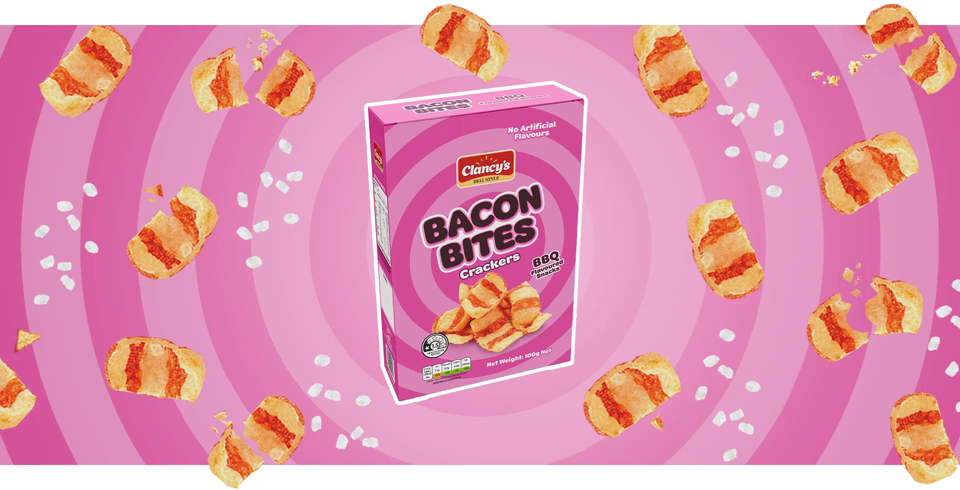 Clancy's Bacon Bites BBQ Crackers box surrounded by scattered cracker pieces on a pink striped background.