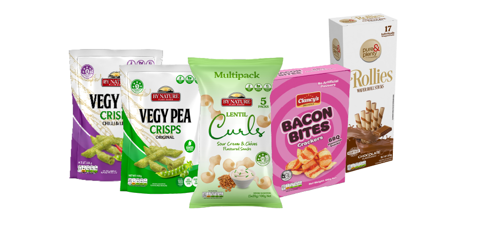 A variety of snack packages including Vegy Pea Crisps, Lentil Curls, Bacon Bites, and Rollies arranged together.