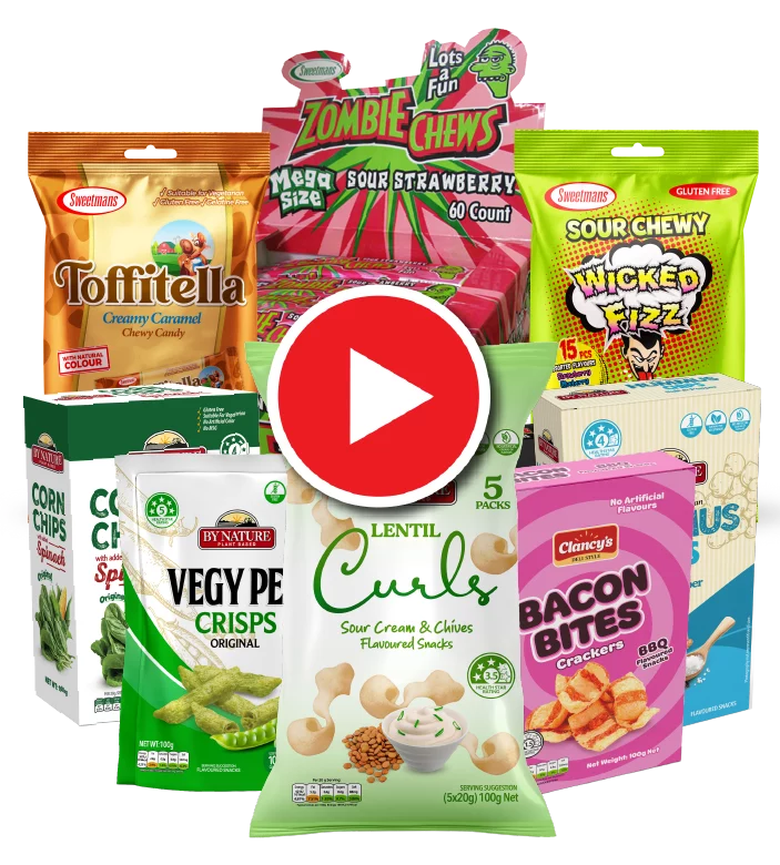 A variety of Sweetmans, By Nature, and Clancy's snack products, featuring Lentil Curls, Zombie Chews, Toffitella, Wicked Fizz, and Spinach Corn Chips, with a red play button overlay at the centre.